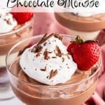 Three stemmed dessert dishes filled with Cottage Cheese Chocolate mousse, one in the front and two in the background. They are topped with whipped cream and chocolate shavings, and garnished with a sliced strawberry with the stem in tact. Text overlay reads: Cottage Cheese Chocolate Mousse