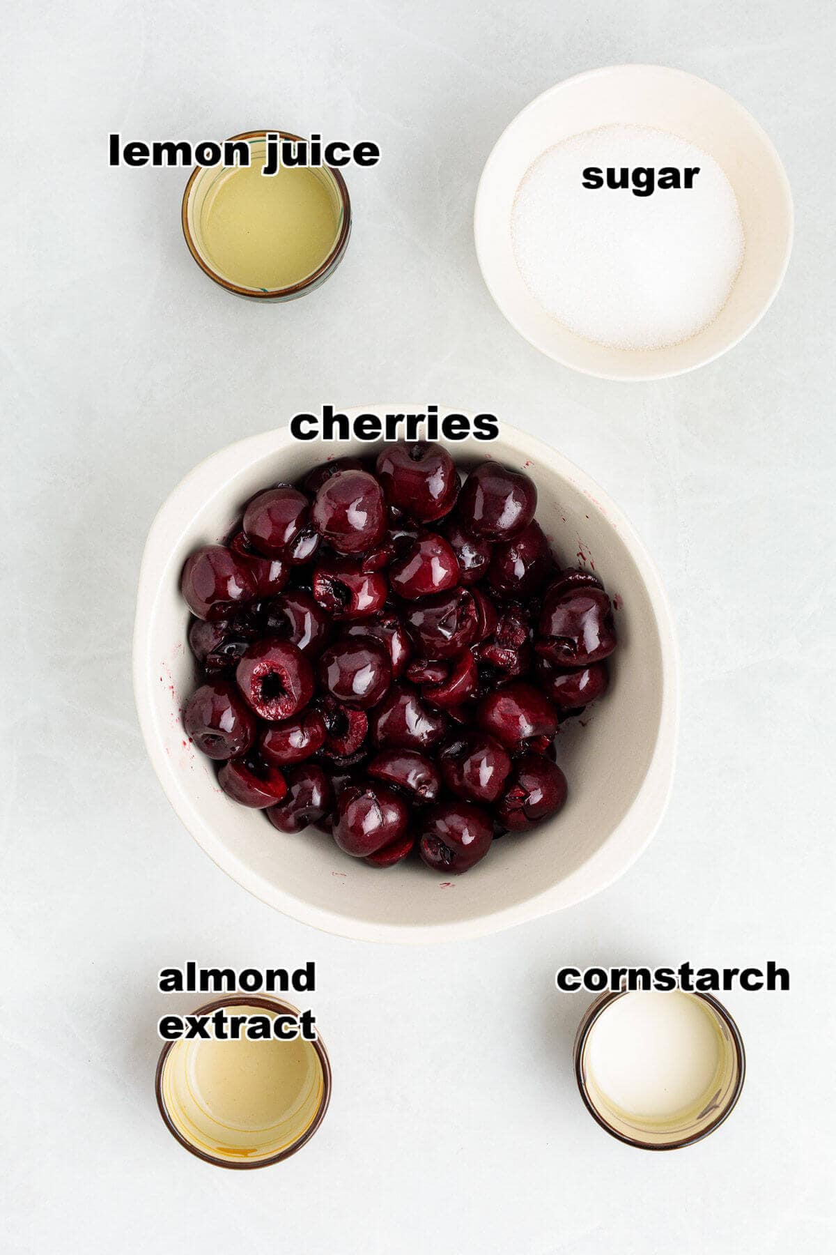 Ingredients to make Cherry Compote: Cherries, sugar, lemon juice, cornstarch slurry, and almond extract.